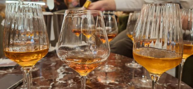 A selection of fine Burgundy wines in glasses on a table for a private and customizable introduction wine masterclass, designed by Céline Dandelot.