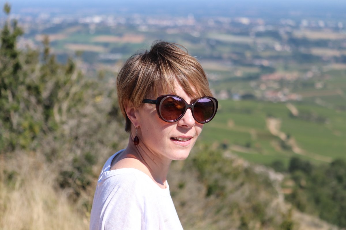 Céline Dandelot in the heart of Burgundy vineyards, showcasing her lifelong passion for the terroir.