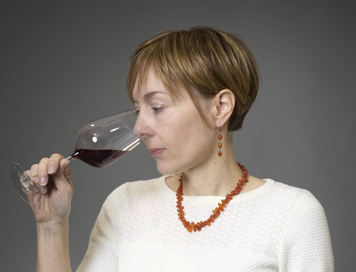 Céline Dandelot, Burgundy wine expert, analyzing the complex aromas of a red wine.