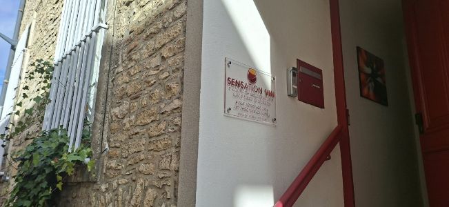 Exterior entrance of Sensation Vin in Beaune, co-founded by Burgundy wine expert Céline Dandelot, featuring the original professional wine tasting class plaque.