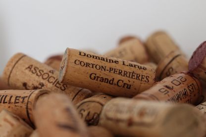 Close-up of wine corks from prestigious Burgundy domains, including Corton-Perrières Grand Cru, representing the variety of bespoke wine experiences.