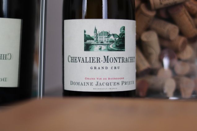A bottle of Chevalier-Montrachet Grand Cru from Domaine Jacques Prieur, showcasing the rare white wines available for bespoke Burgundy tasting experiences.