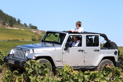 Céline Dandelot exploring the Burgundy vineyards in a 4x4, illustrating the quest for the ultimate Chardonnay and white wine appellations.